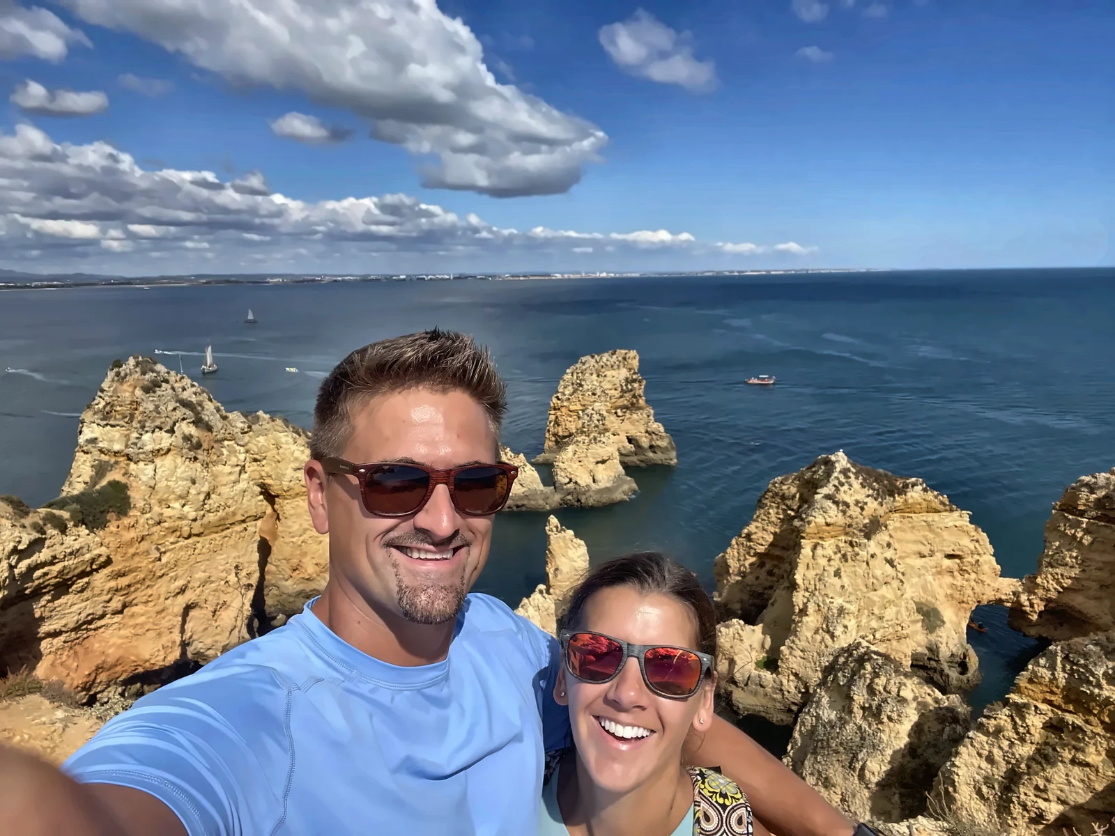 Kyle and Kailah taking a selfie on the clifftop above the sea stacks of Ponta da Piedade, Lagos