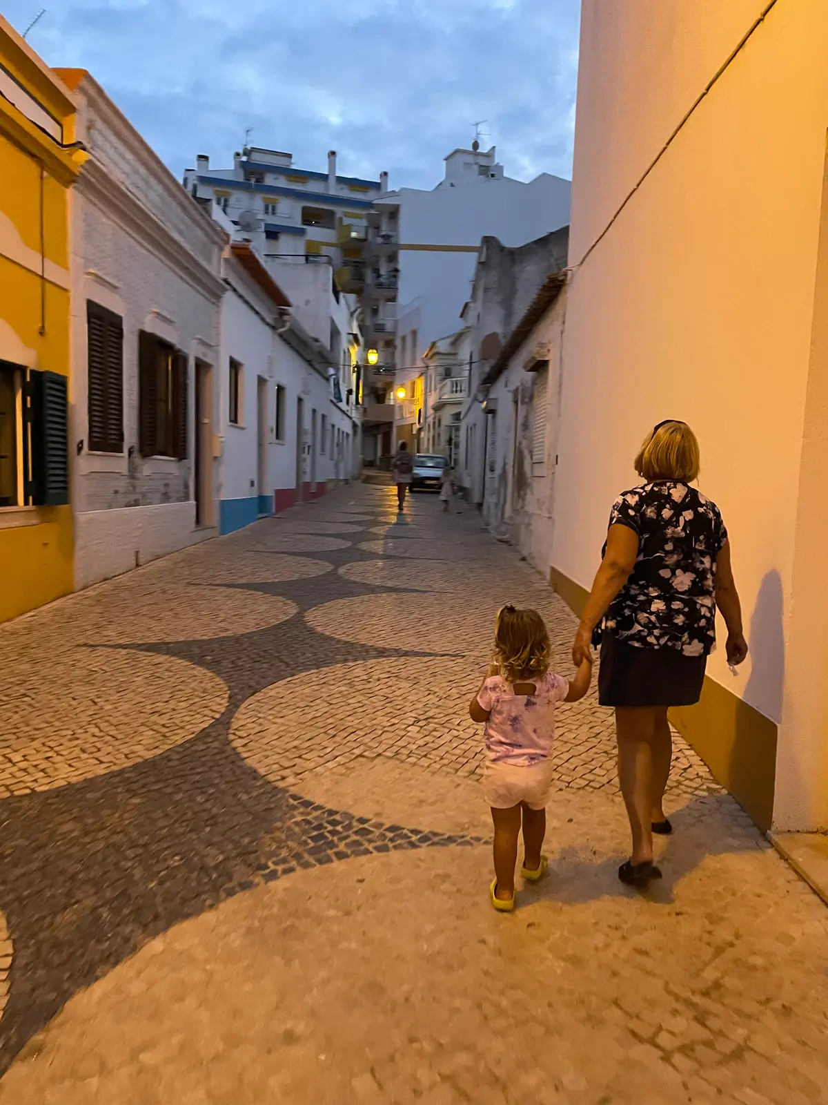A warm September evening walk hand in hand through the tiled streets of old town Lagos, Portugal