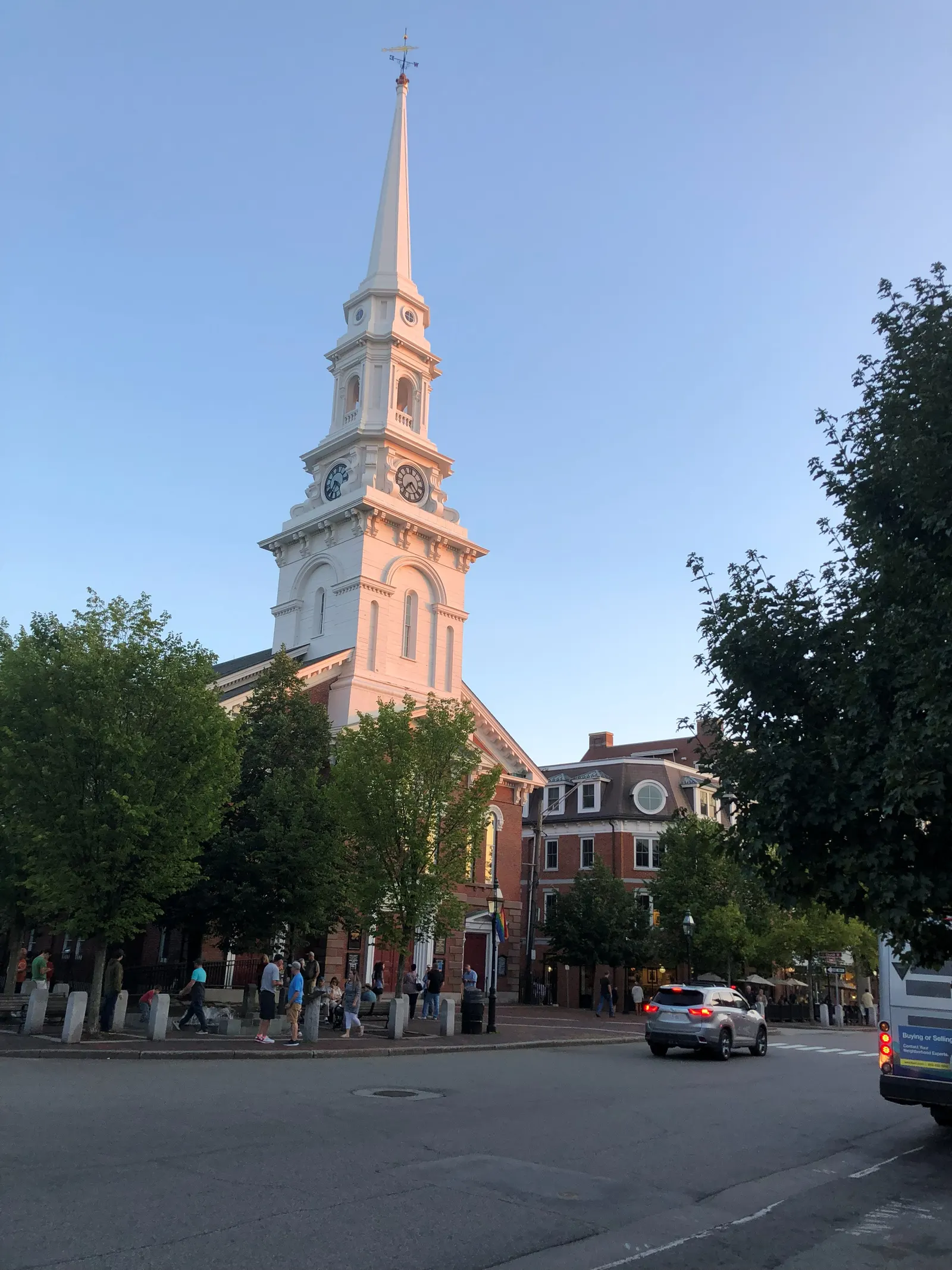 The white steeple of North Church above Market Square in downtown Portsmouth, NH, on a summer evening