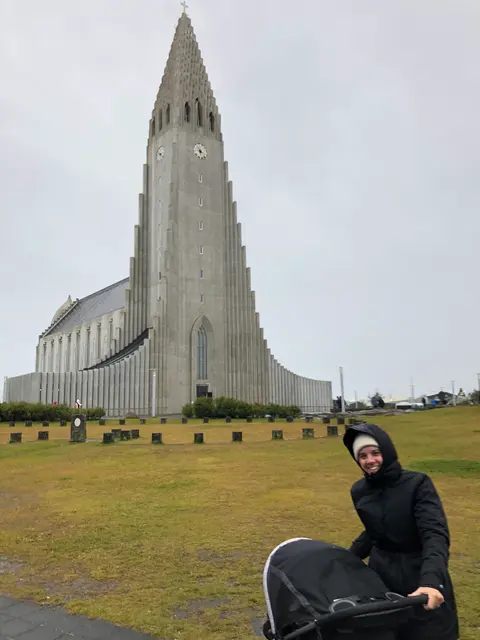 Pushing a stroller past Hallgrimskirkja church in Reykjavik